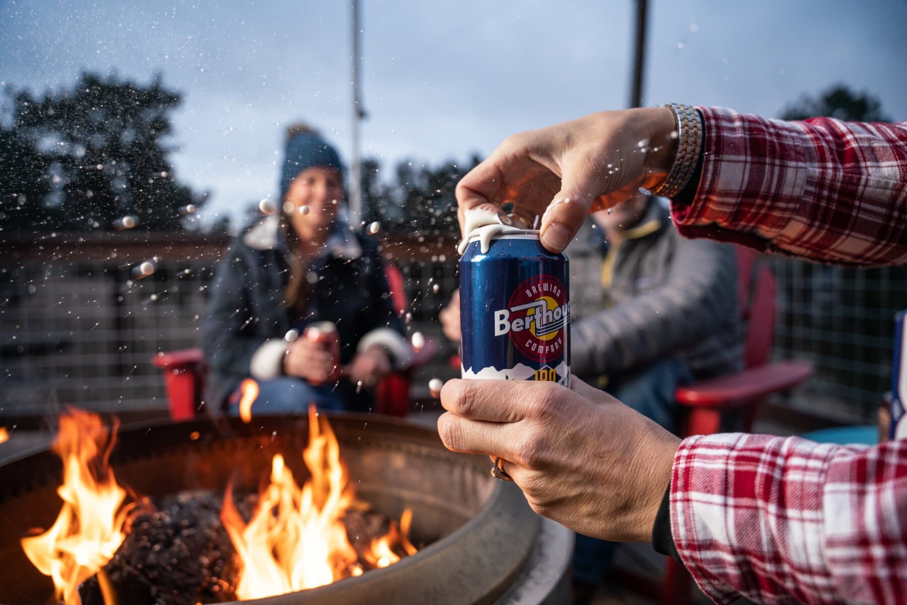 Cracking a can by the fire pit at dusk