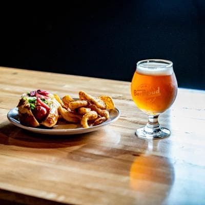 Hot dog with fries and a beer