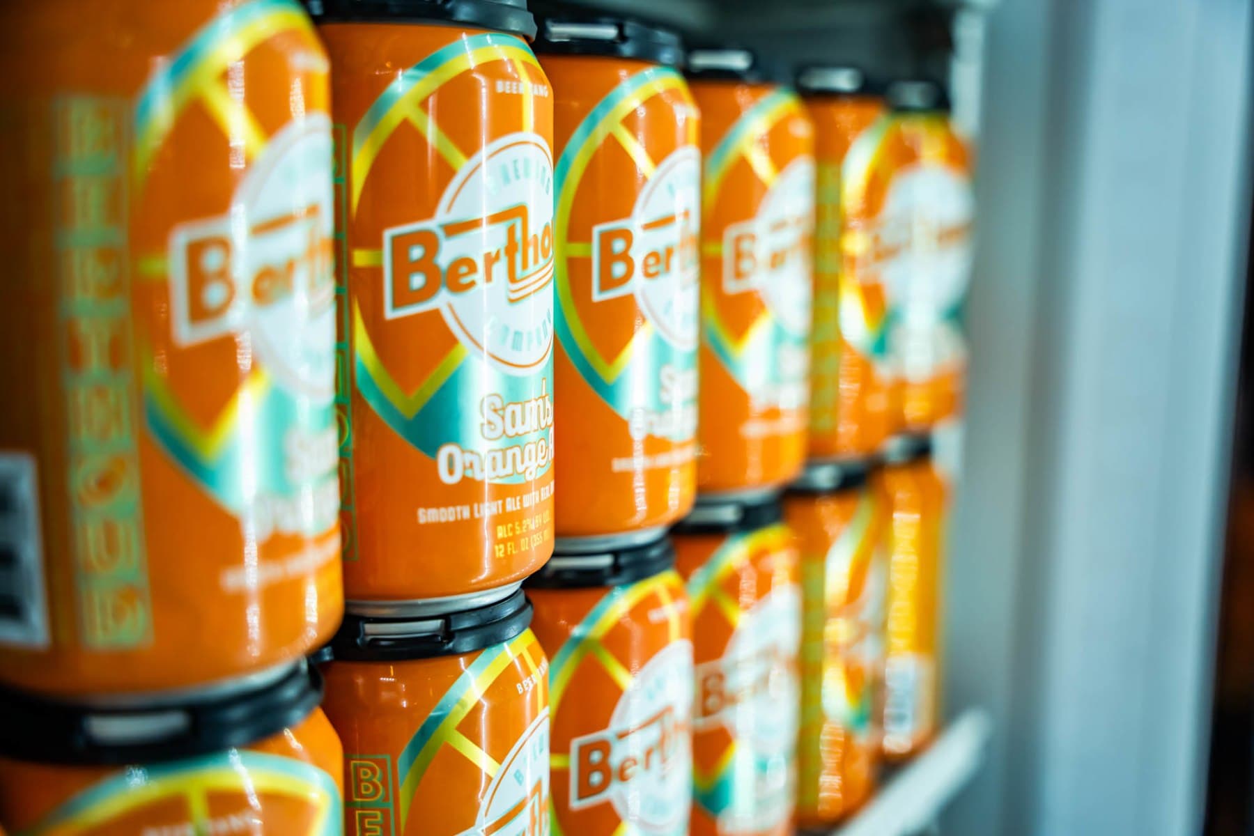 Sam's Orange Ale cans stacked in the cooler