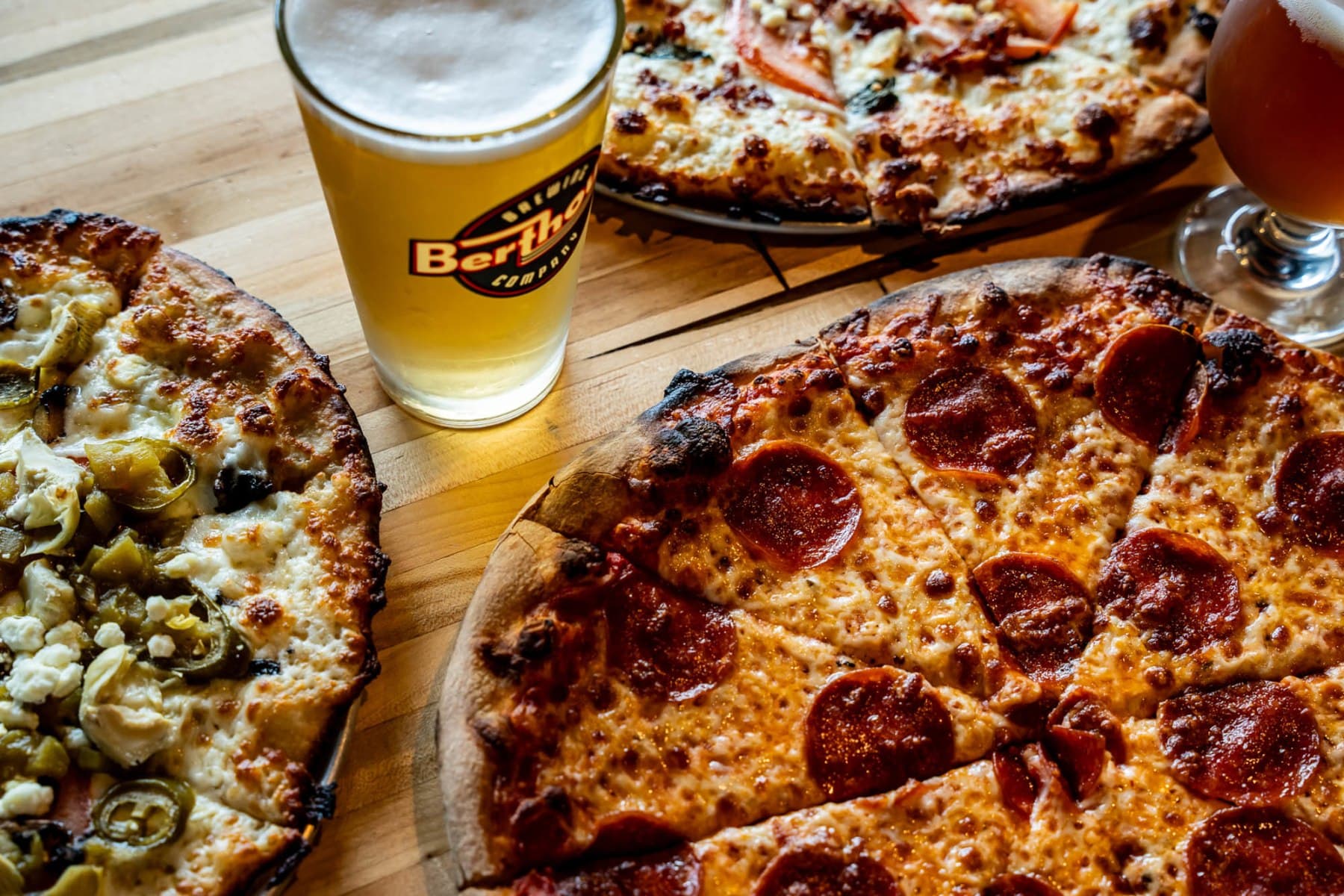 Pepperoni and specialty pizzas with a pint