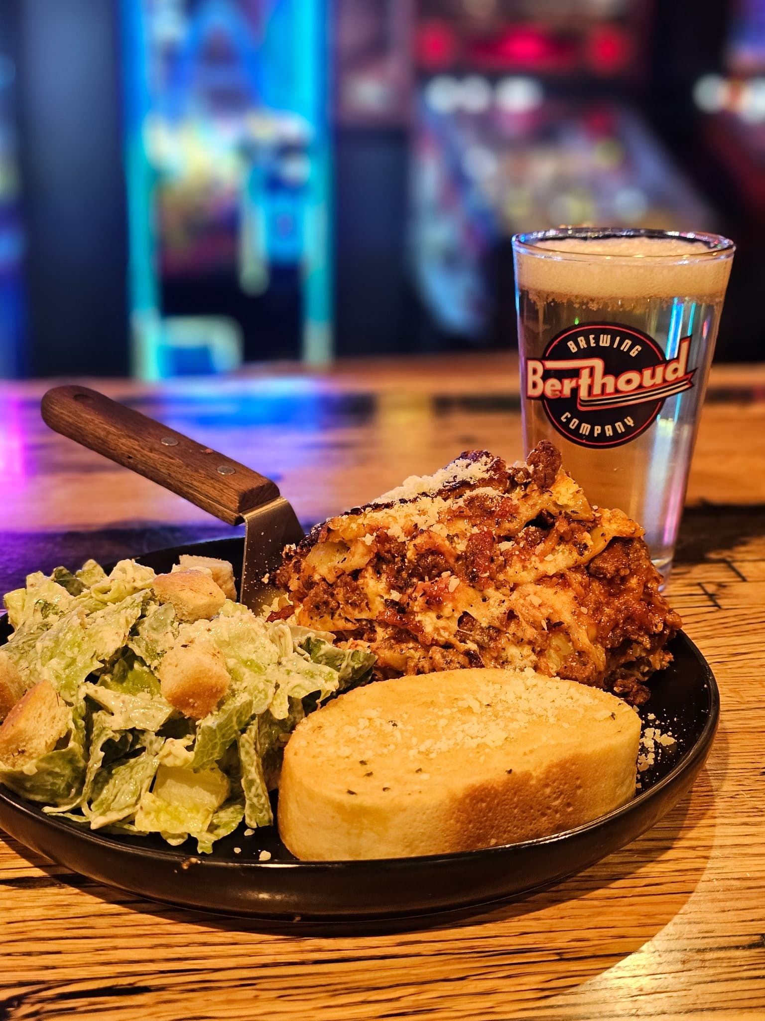 A hearty scratch-kitchen plate served with a Berthoud pint